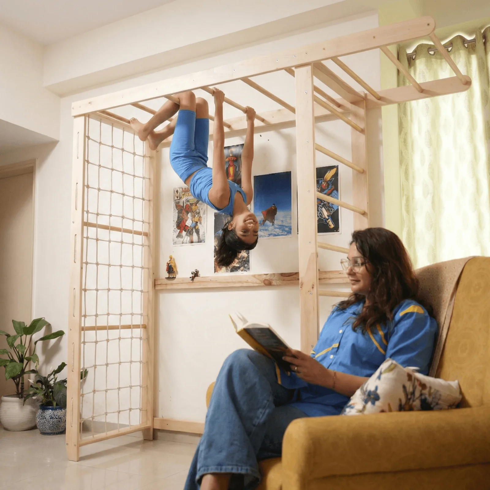 Child hanging upside down on Titan Tower while parent reads