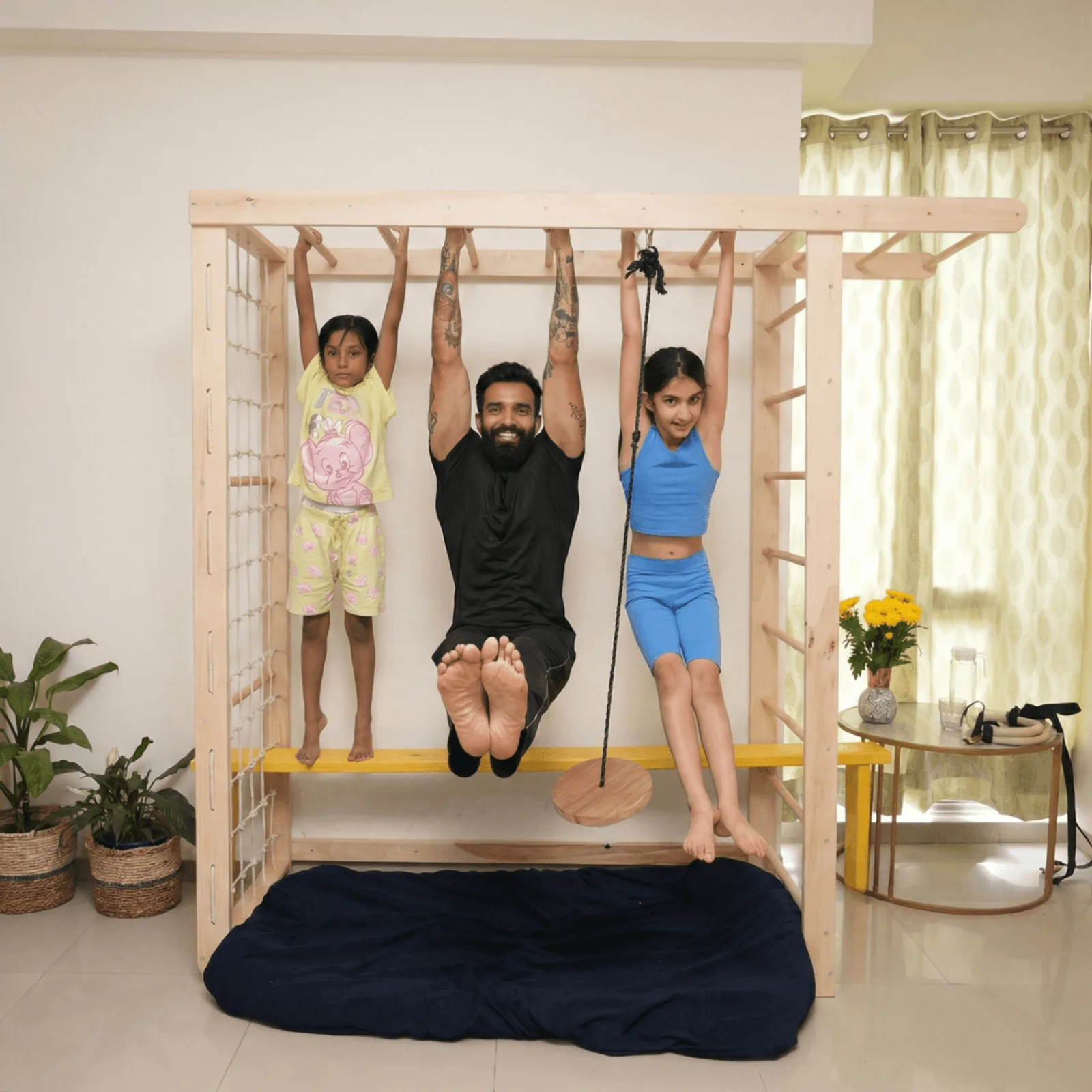 Family fitness on Titan Tower - dad and kids hanging together